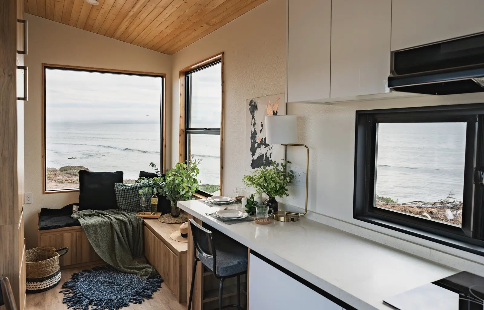 Clever Tiny Homes interior photo showing kitchen with long quartz countertop and living space.